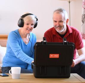 Senior man and woman taking Online Hearing Care home test