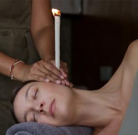 Woman getting ear candle treatment