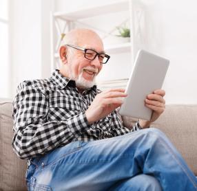 Elderly man using tablet